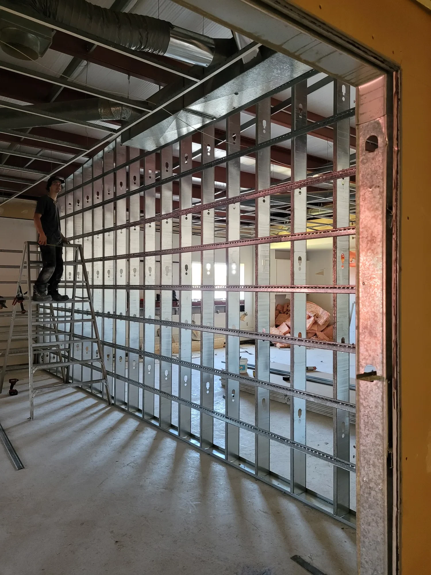 A commercial indoor redesign project with a new wall being built